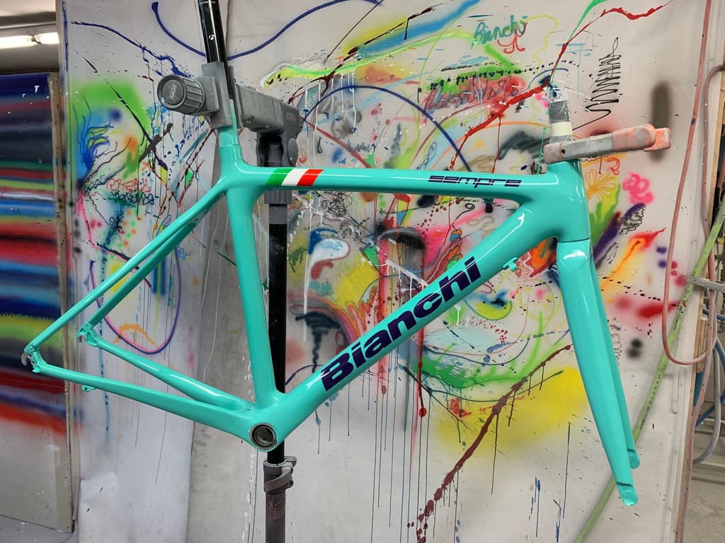 Bianchi Sempre road frame refinished in Bianchi's signature celeste green with the Italian flag and factory lettering reproduced.