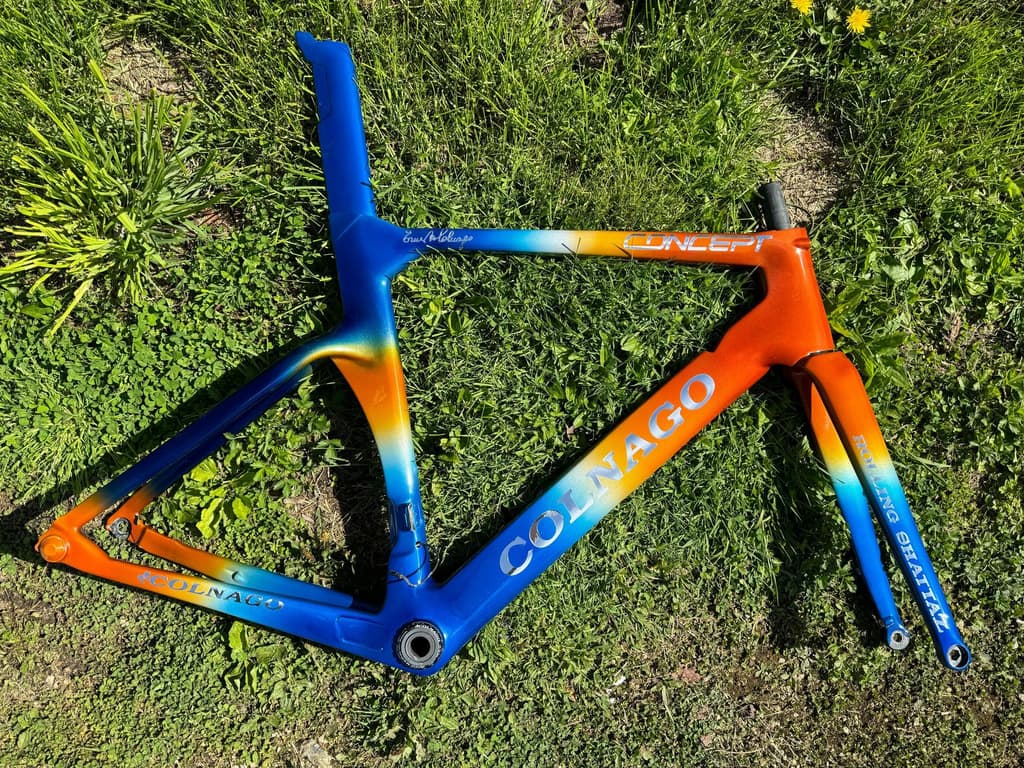 Colnago road frame finished with a bold fade from blue to orange.