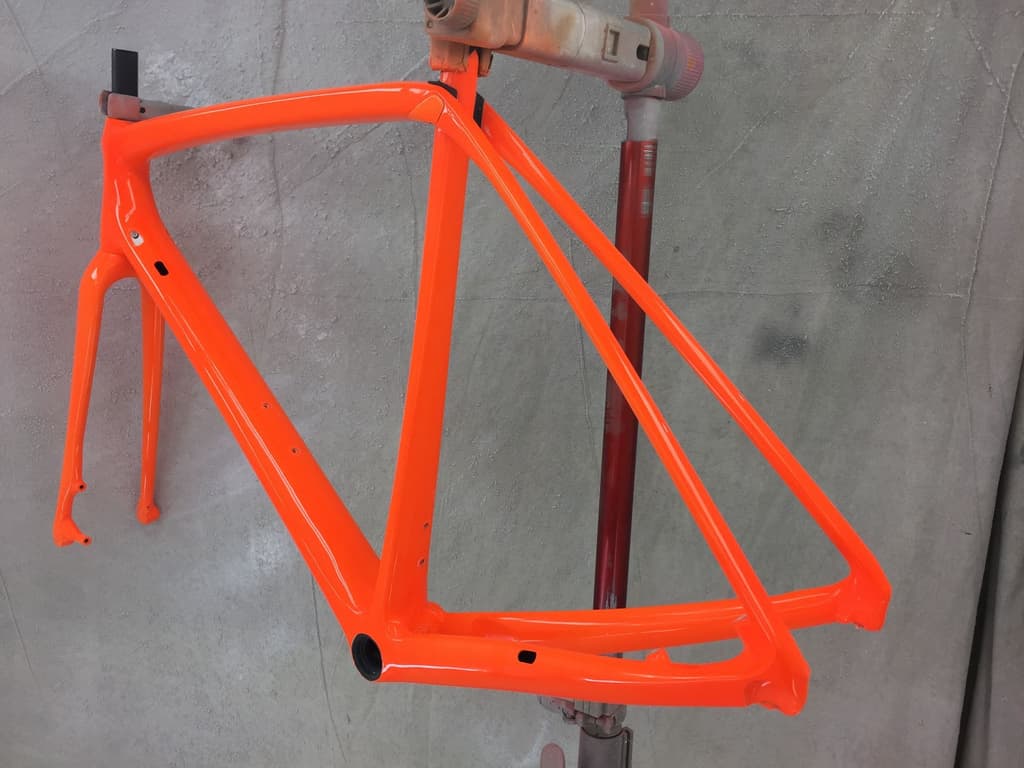 Road frame finished in a single-color bright gloss orange.