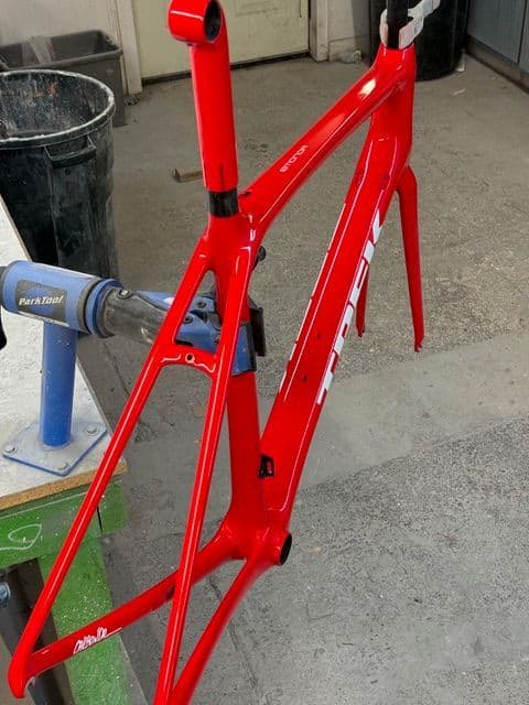 Road frame refinished in gloss red, shown on the shop repair stand.