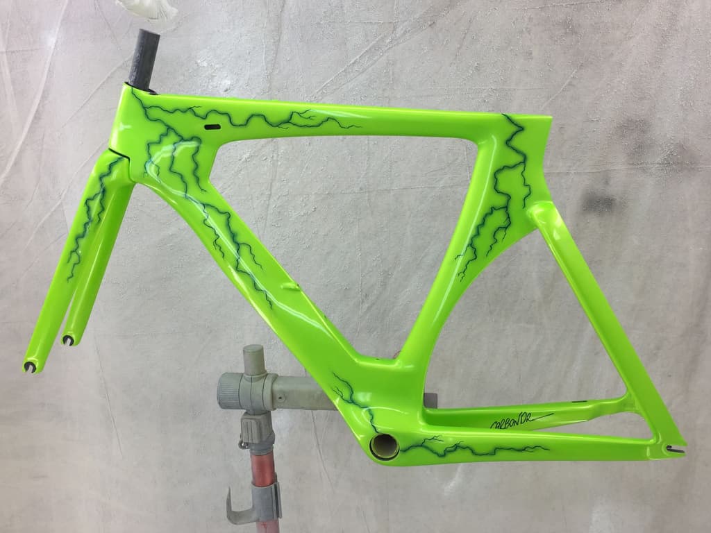 Road frame refinished in bright green with a custom dark branching graphic sprayed over the top tube and down tube.