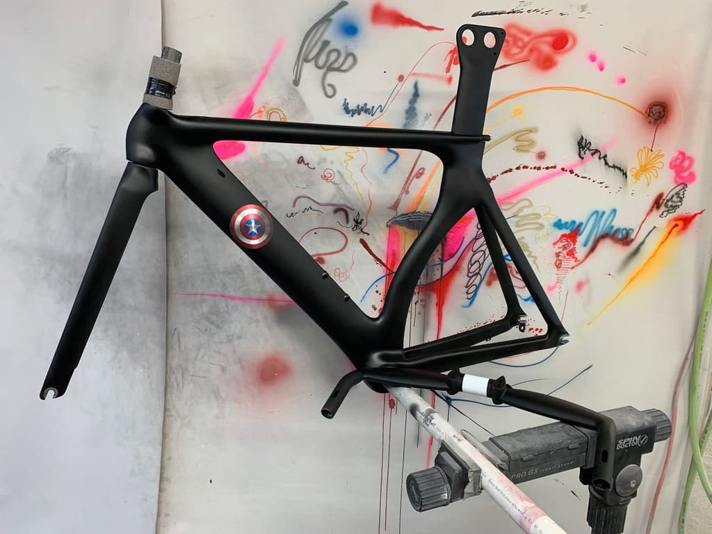 Road frame refinished in matte black with a custom shield-emblem decal added to the down tube.
