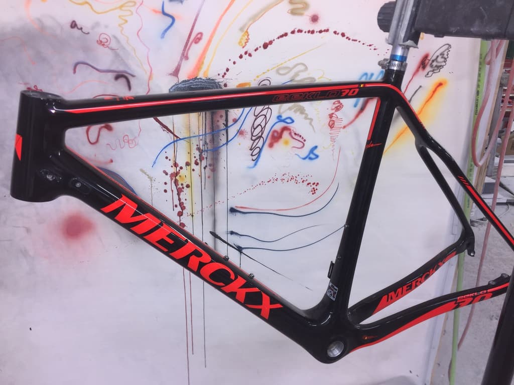 Eddy Merckx road frame refinished in gloss black with red "Merckx" lettering reproduced.