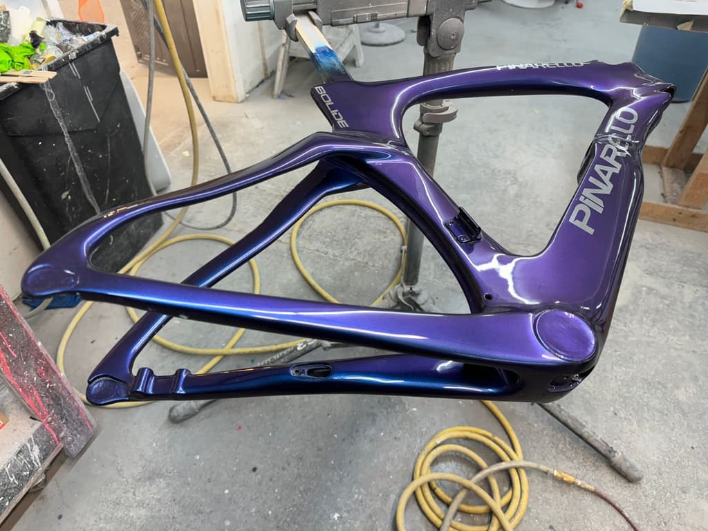 Pinarello Bolide time trial frame refinished in a color-shifting purple-to-blue paint with the Pinarello and Bolide lettering reproduced.