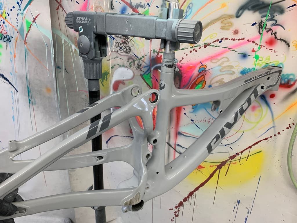 Pivot Switchblade mountain bike frame refinished in a gloss light grey with factory-style lettering reproduced.