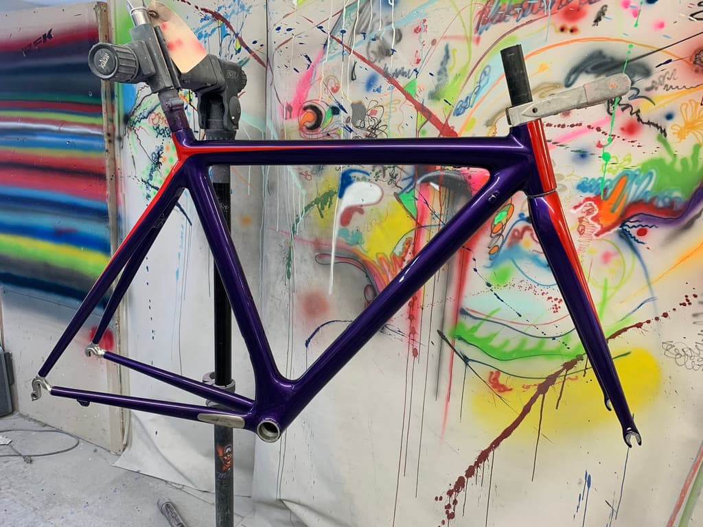 Frame refinished in gloss purple with a red accent stripe along the top tube and fork leg.