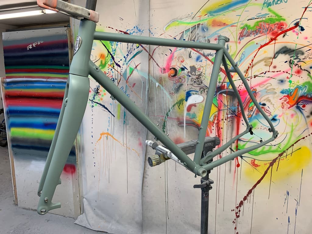 Metal gravel/touring frame refinished in a matte sage green.