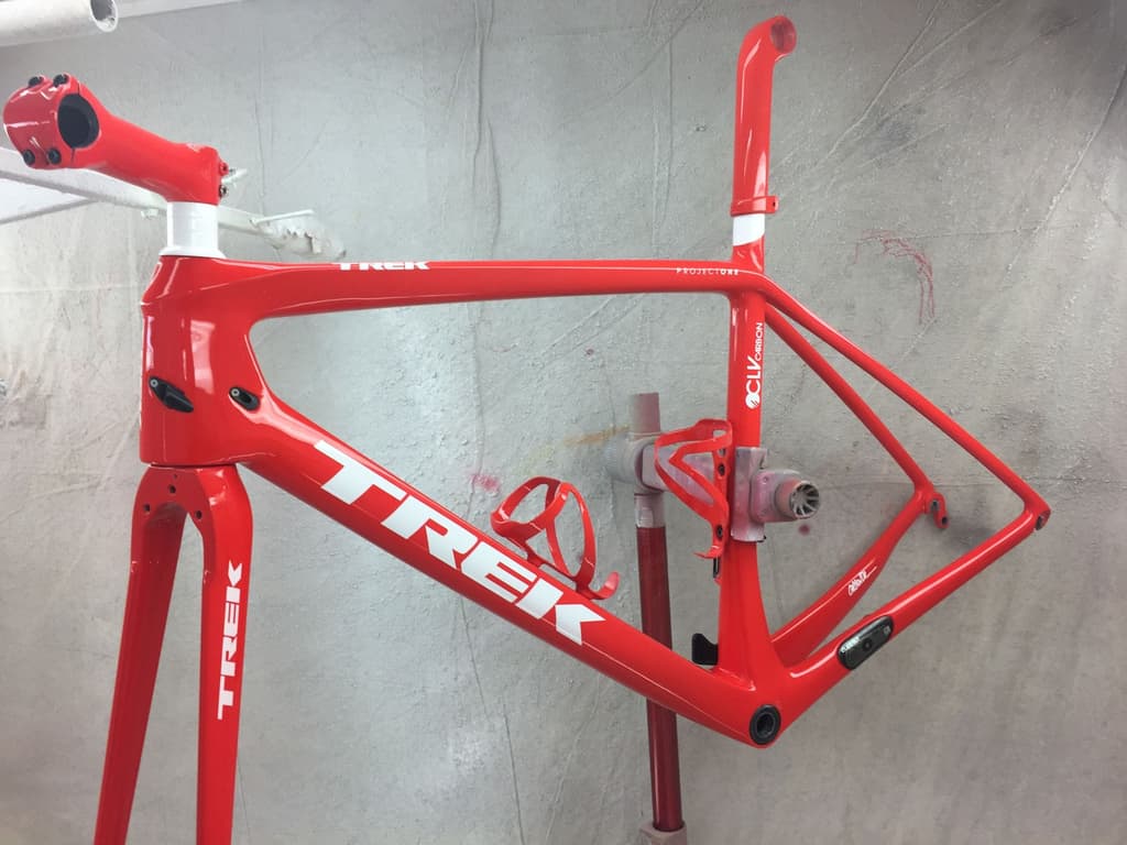 Trek OCLV Carbon road frame refinished in bright gloss red with white Trek and Project One lettering reproduced.