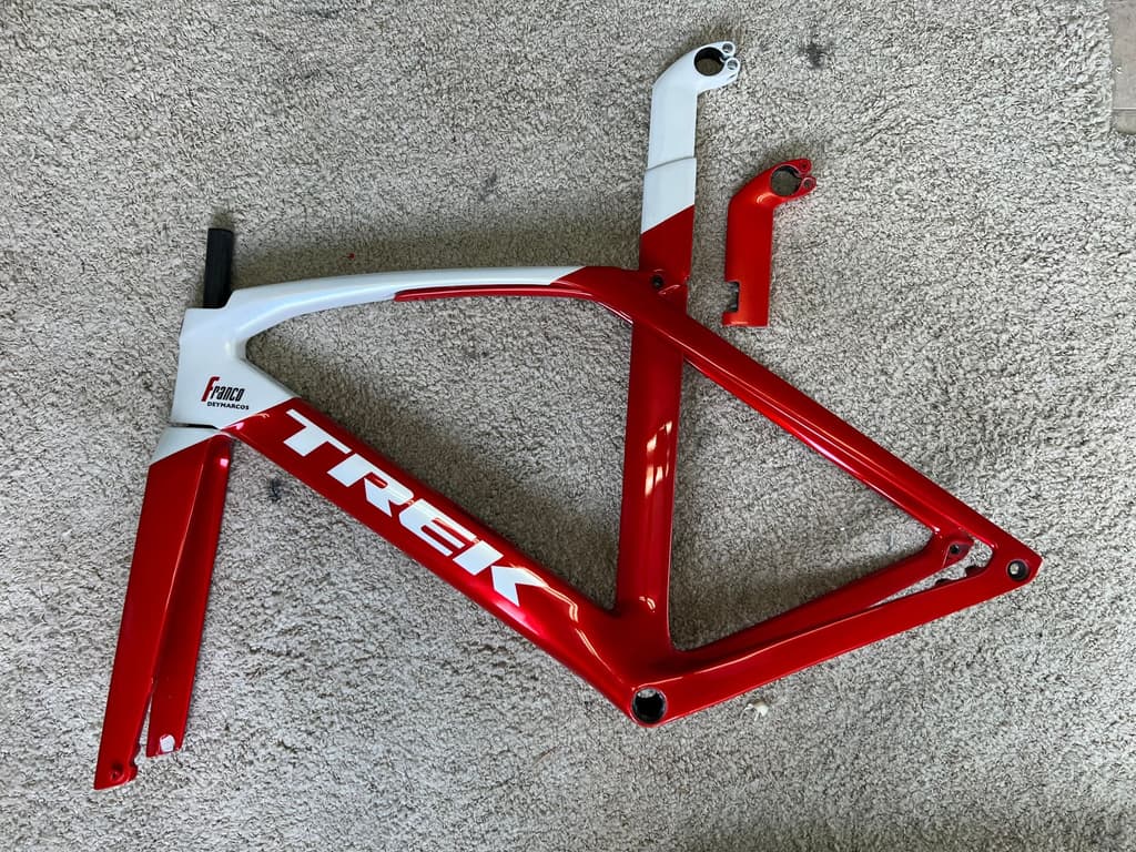 Trek aero road frame refinished in red and white with custom personalized lettering added to the top tube.