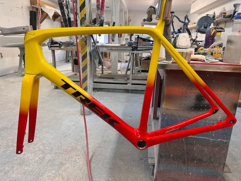 Trek carbon road frame finished with a custom gloss fade from yellow at the head tube and top tube to red at the fork legs and seat stays.